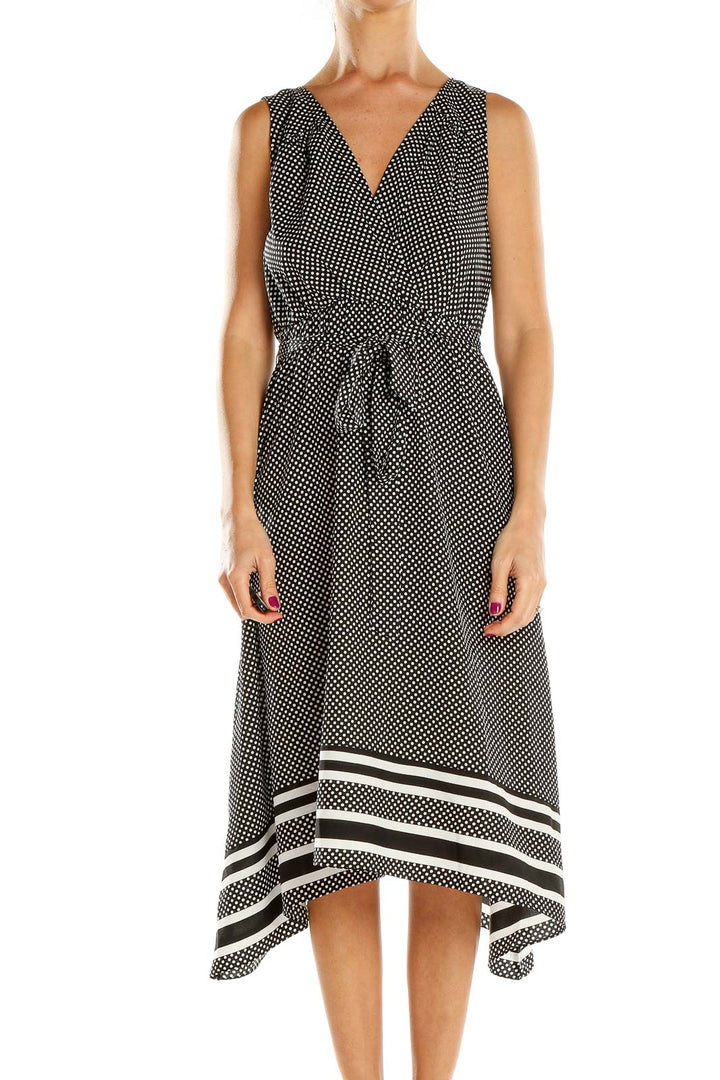 Front view of black and white polka dot maternity midi dress with V-neck and wrap bodice
