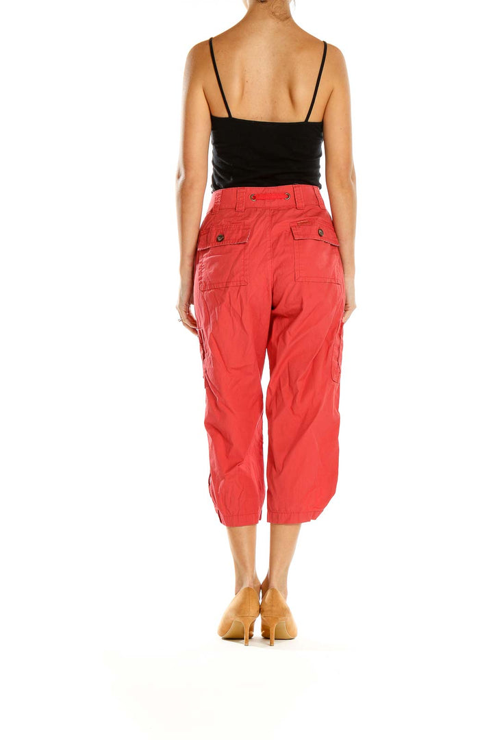 Side view of woman wearing red Lee cargo capri pants