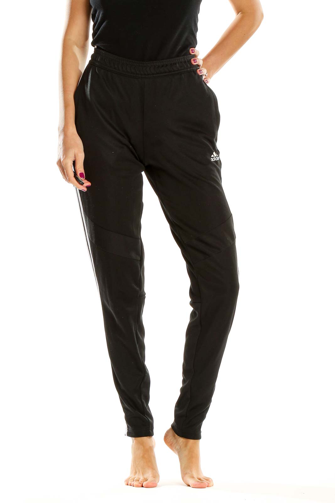 Front view of black Adidas track pants with white stripes