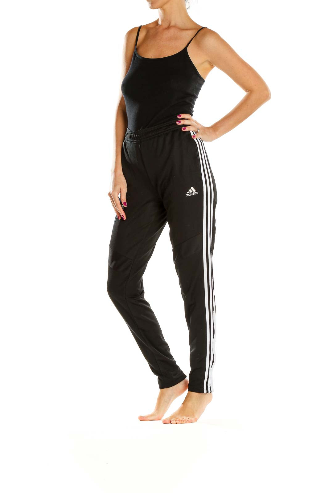 Front view of black Adidas track pants with white stripes