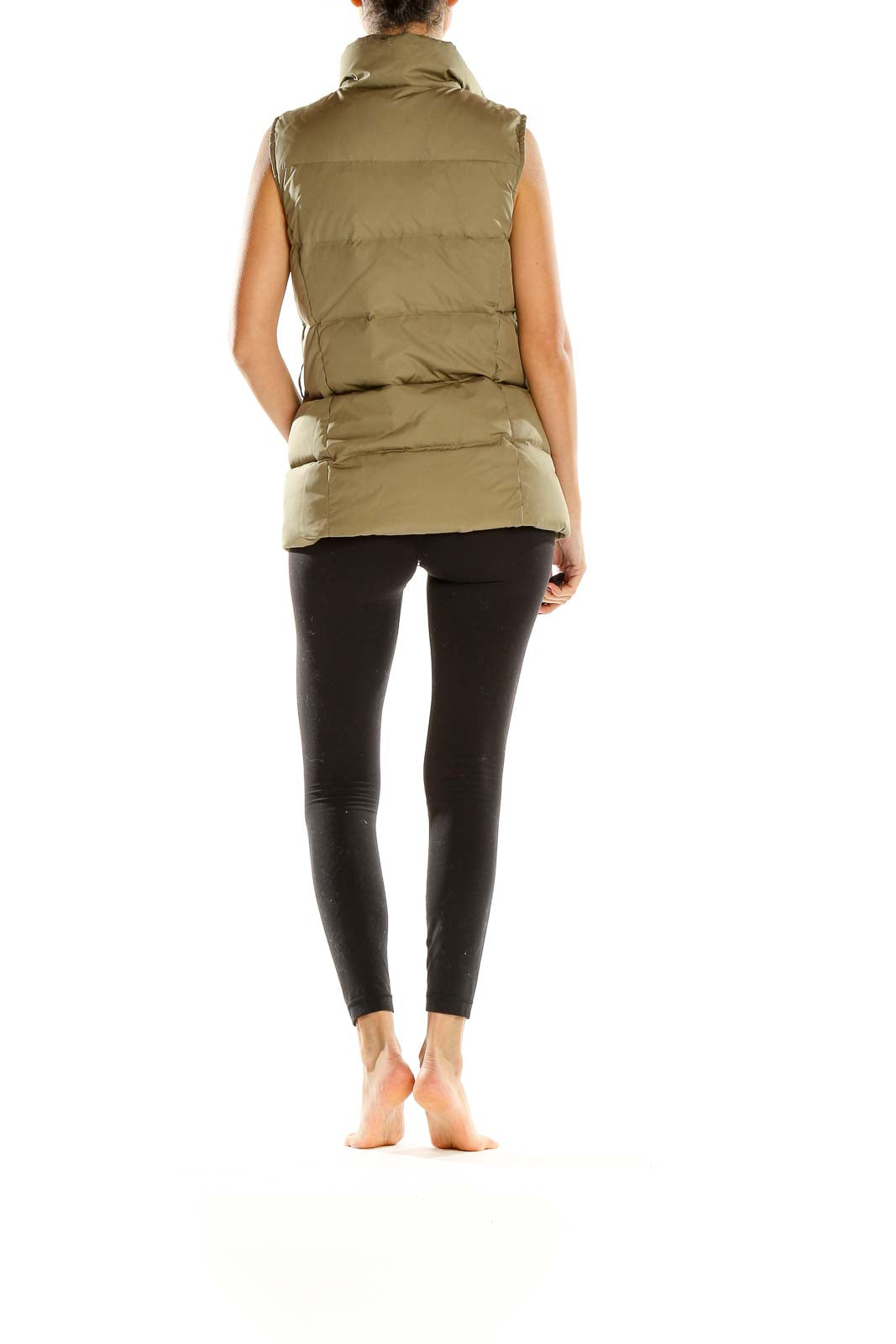 Side view of olive Gap quilted puffer vest on model with black leggings