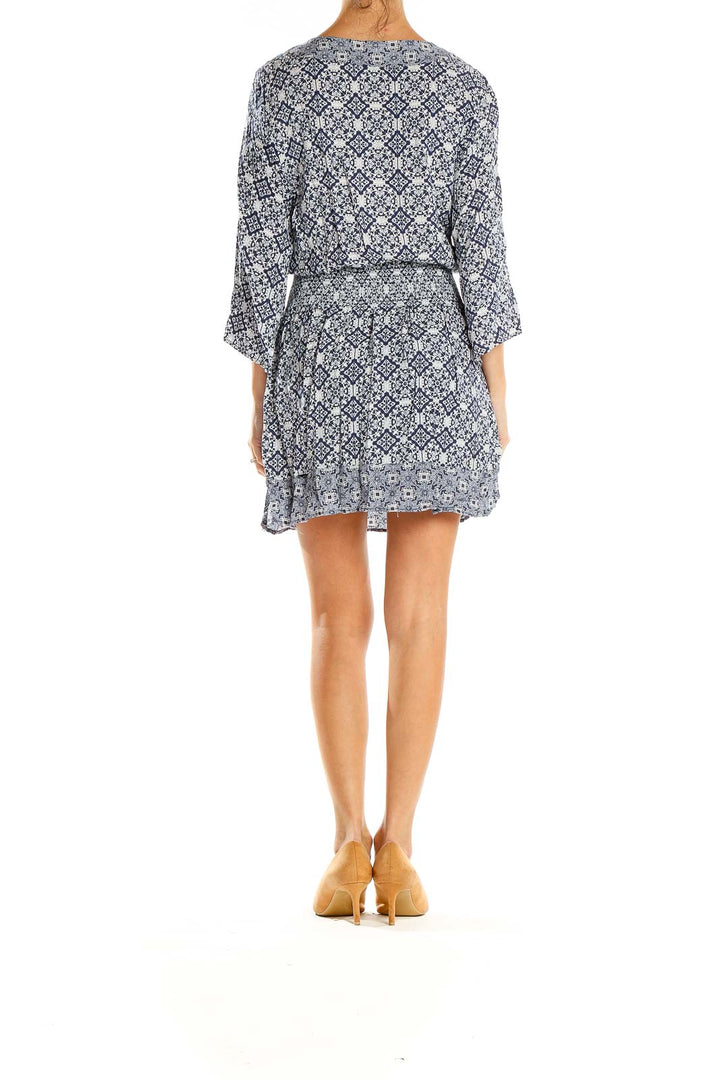 Side view of navy floral print mini dress showing smocked waist detail by JACK by BB Dakota