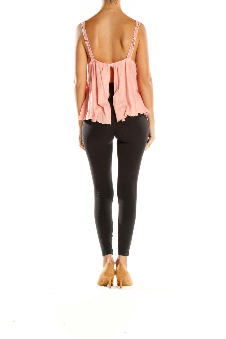 Side view of pink lace-trimmed tiered tank top by Kimchi Blue with black leggings