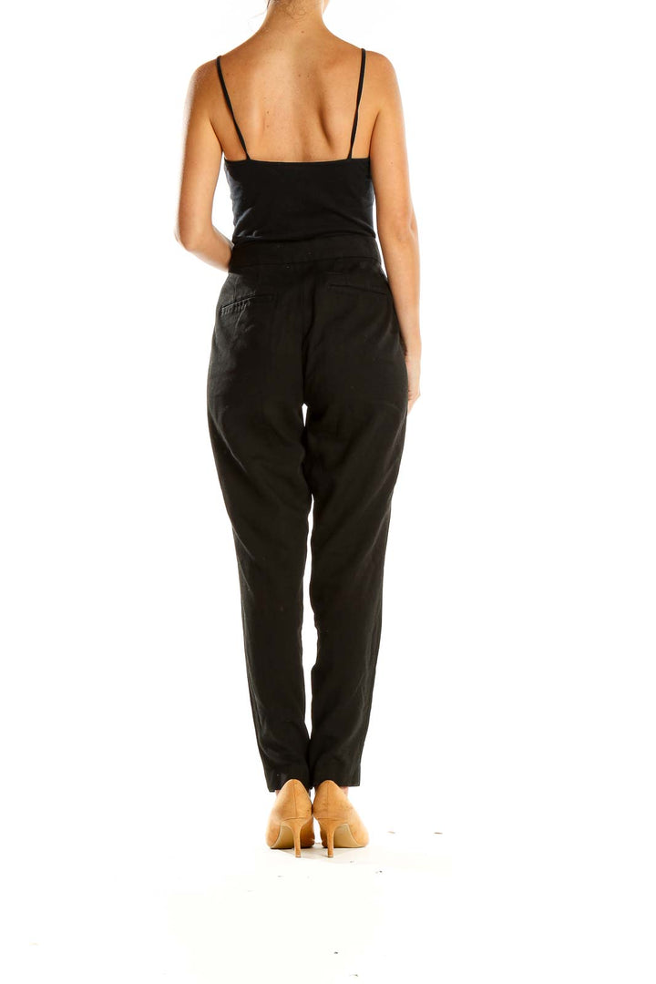 Side view of Gap black straight-leg trousers on model with tan heels