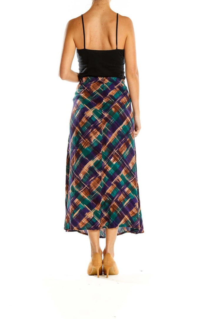 Side view of model wearing Dena Lauren multicolor plaid midi skirt with black top