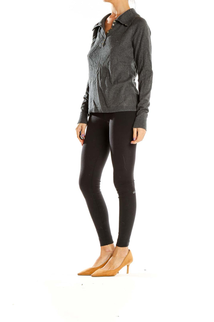 Full-length view of model wearing Eddie Bauer gray collared knit sweater with black leggings
