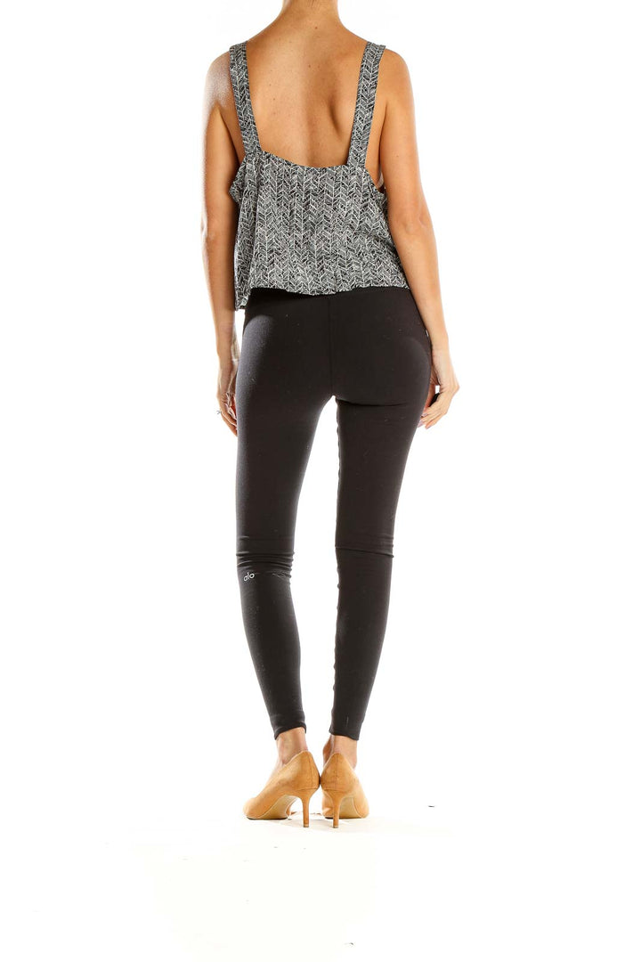 Back view of BP gray herringbone print sleeveless top paired with black leggings