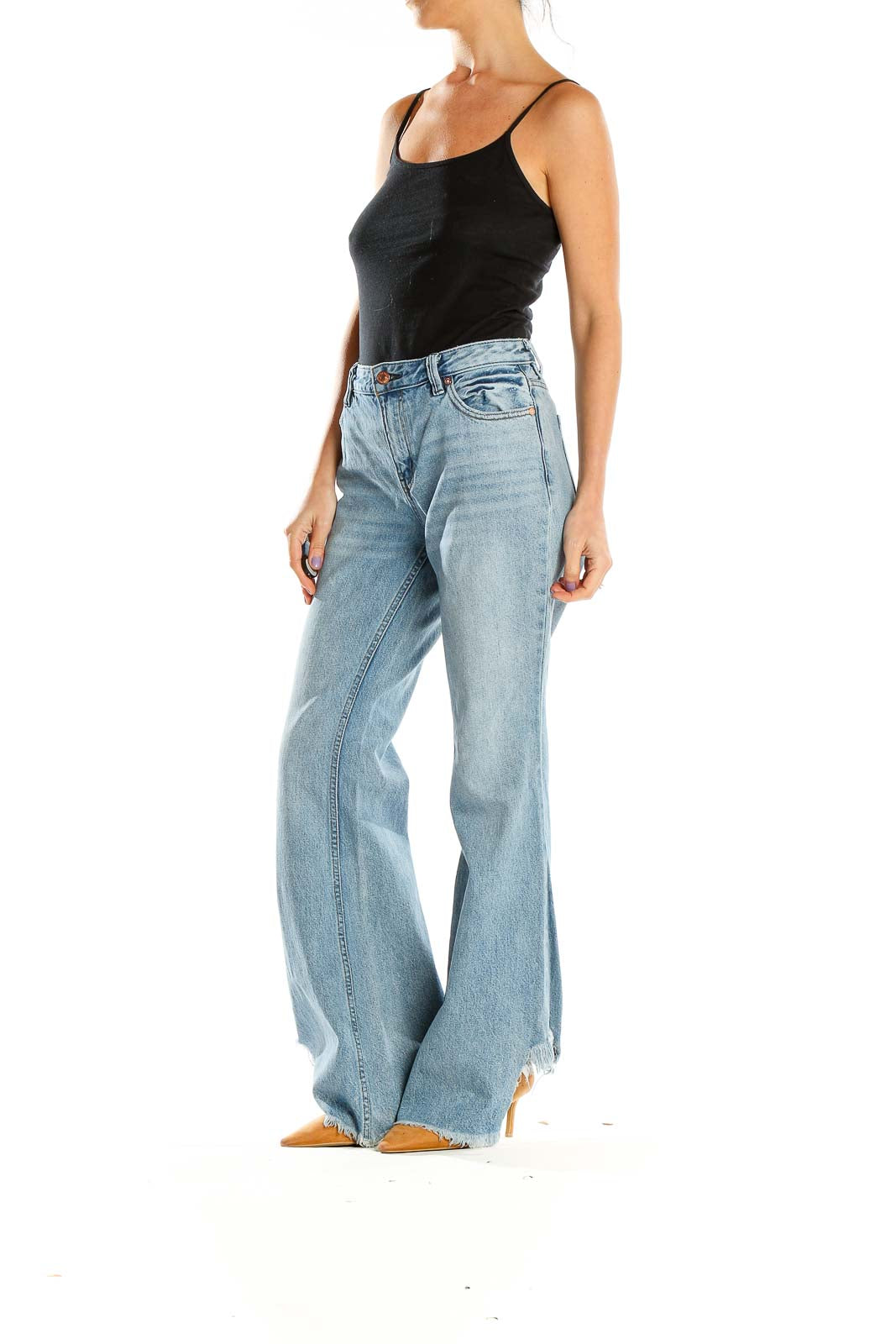 Front view of WE THE FREE light blue flared jeans with high waist and raw hems