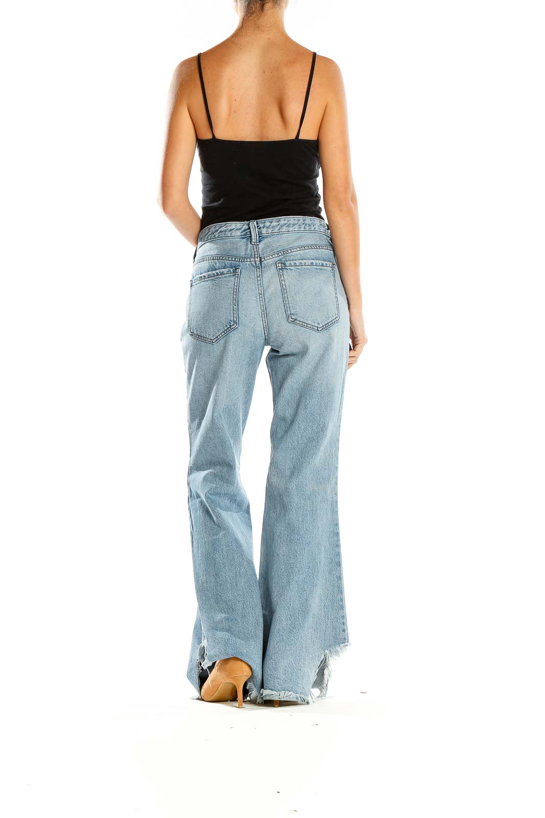 Side view of WE THE FREE light blue flared jeans showing dramatic flare from knee to hem