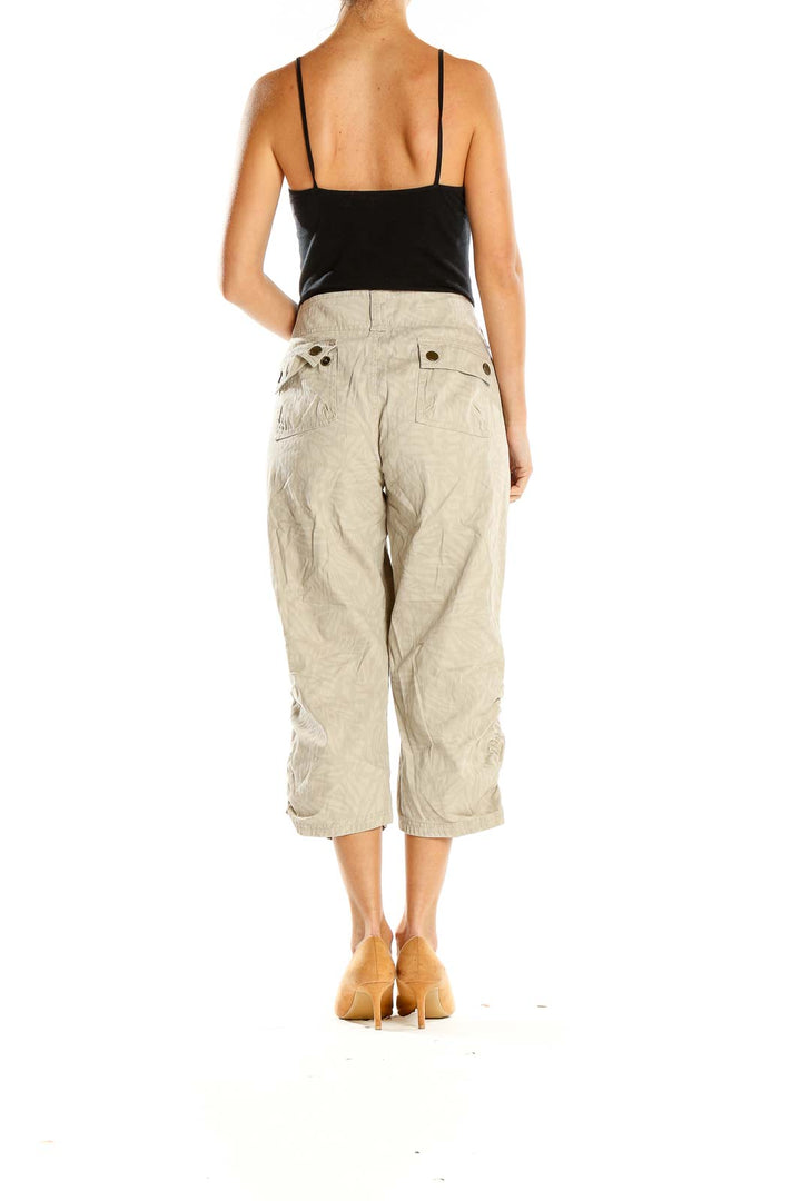 Side view of model wearing MICHAEL Michael Kors beige cropped linen blend pants