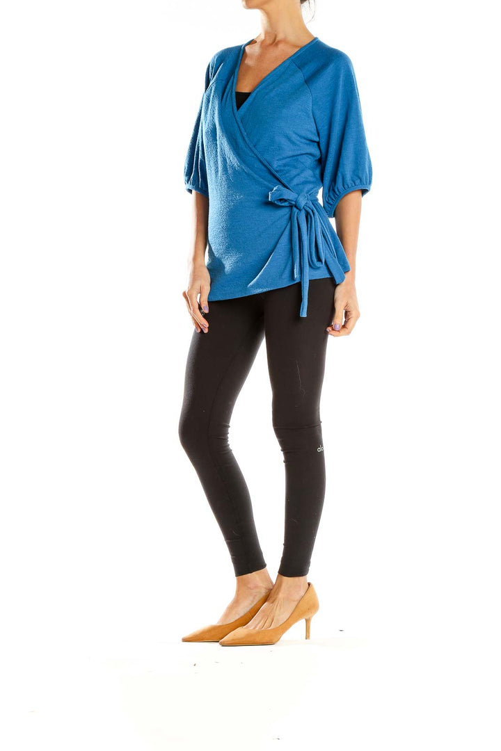 Front view of Banana Republic blue wrap-style top with balloon sleeves