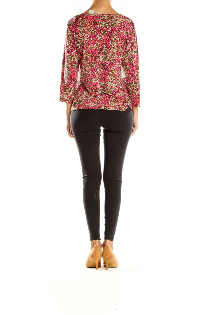 Side view of Laura Ashley pink floral V-neck blouse on model with black pants