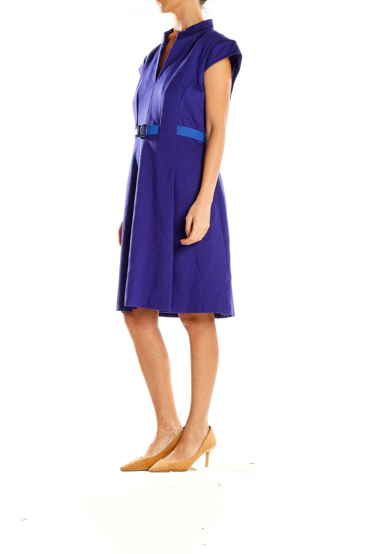 Front view of purple Trina Turk A-line dress with cap sleeves and blue bow accent