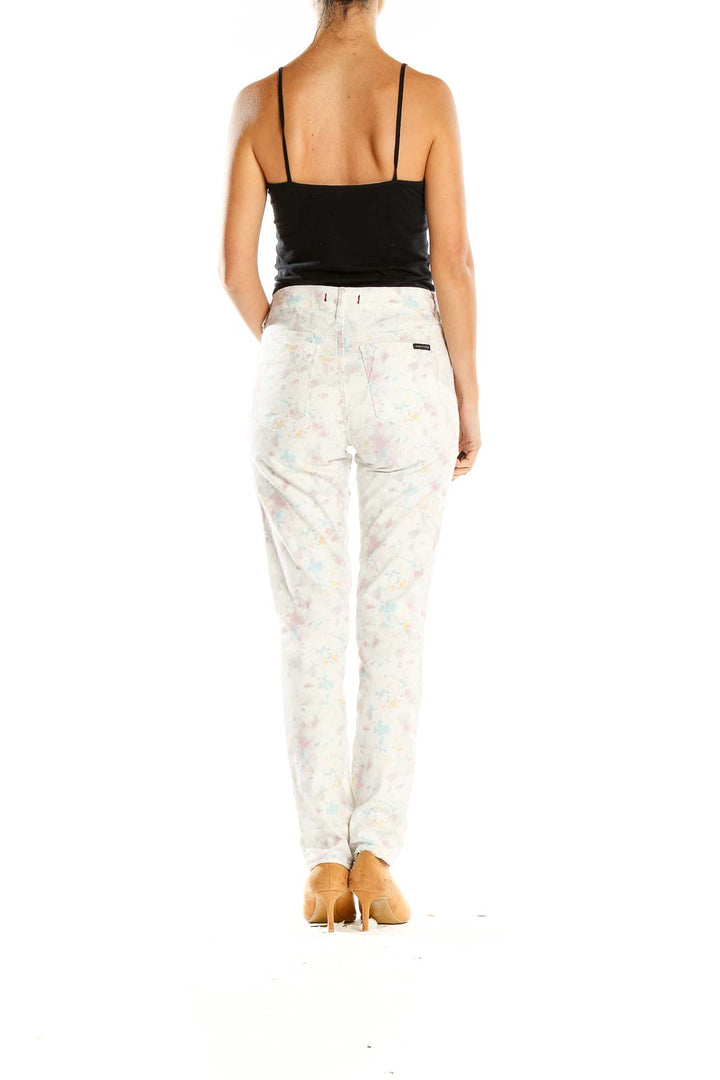 Back view of Sanctuary white floral print skinny jeans on model