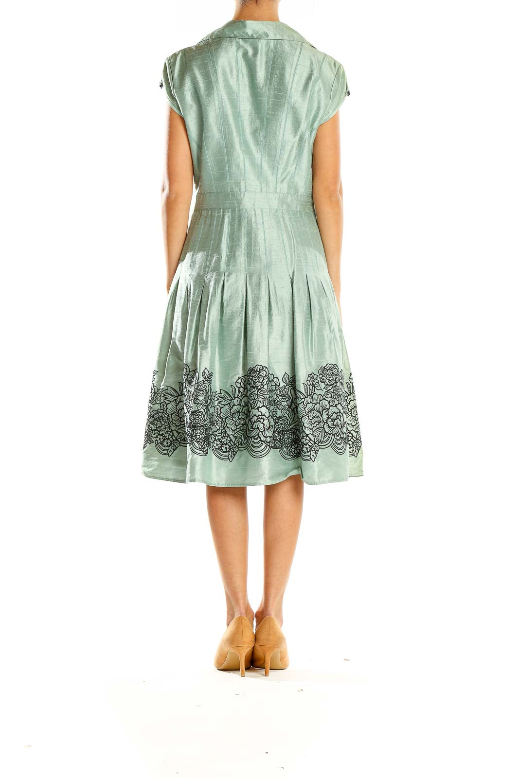 Side view of mint green Kay Unger dress showing pleated skirt and floral embroidery
