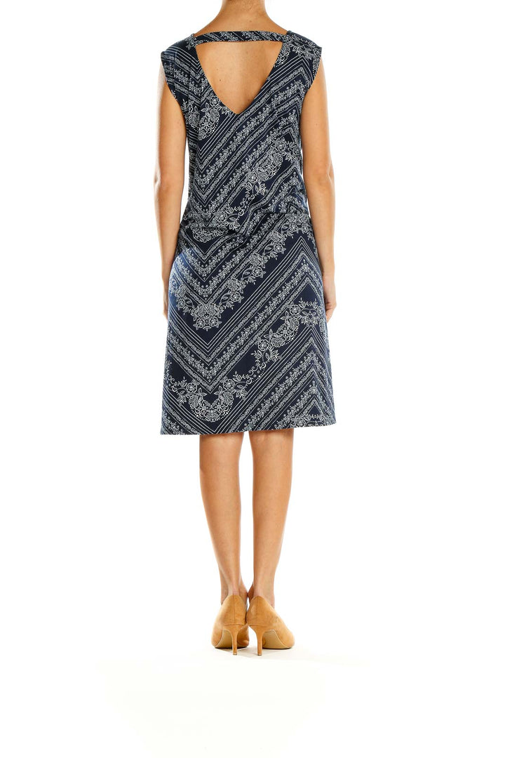 Back view of Nine Britton Navy Floral Paisley Chevron Midi Dress on model