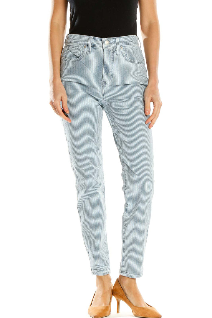 Front view of Madewell light blue striped high-waisted jeans on model