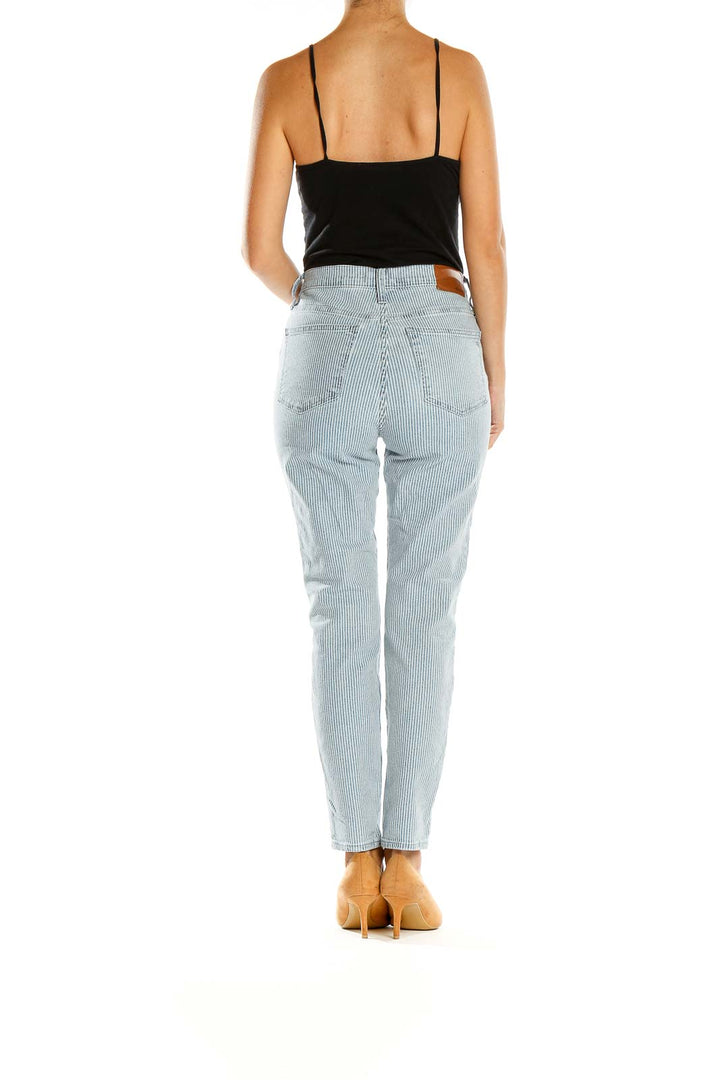 Side view of Madewell light blue striped high-waisted jeans on model