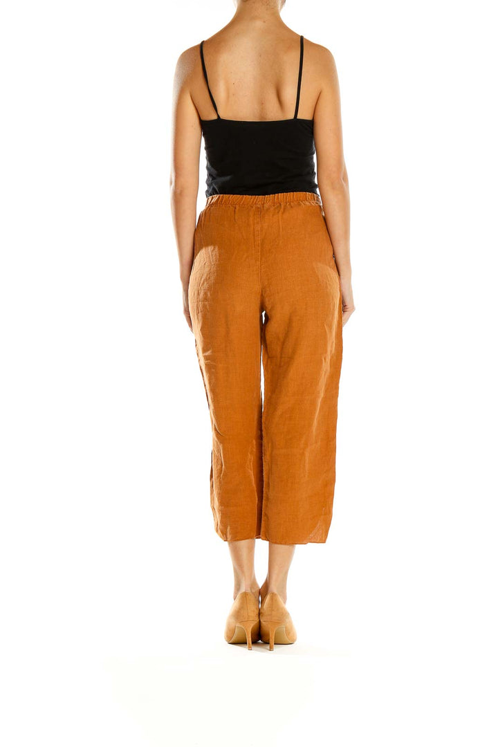 Side view of model wearing orange linen cropped wide-leg pants from Click by Color Me Cotton