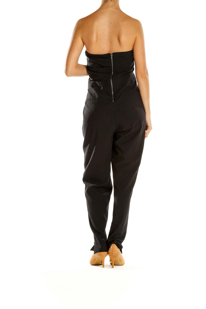 Back view of black strapless jumpsuit by Silence + Noise
