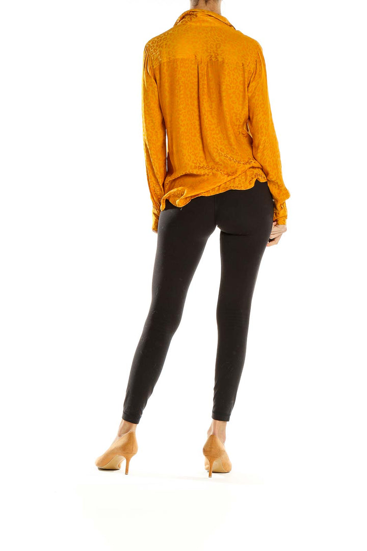 Side view of Banana Republic golden leopard print button-down shirt on model