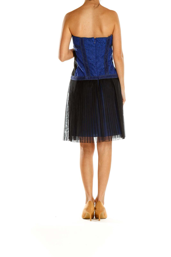 Side view of BCBG MaxAzria blue strapless cocktail dress showing tulle skirt detail