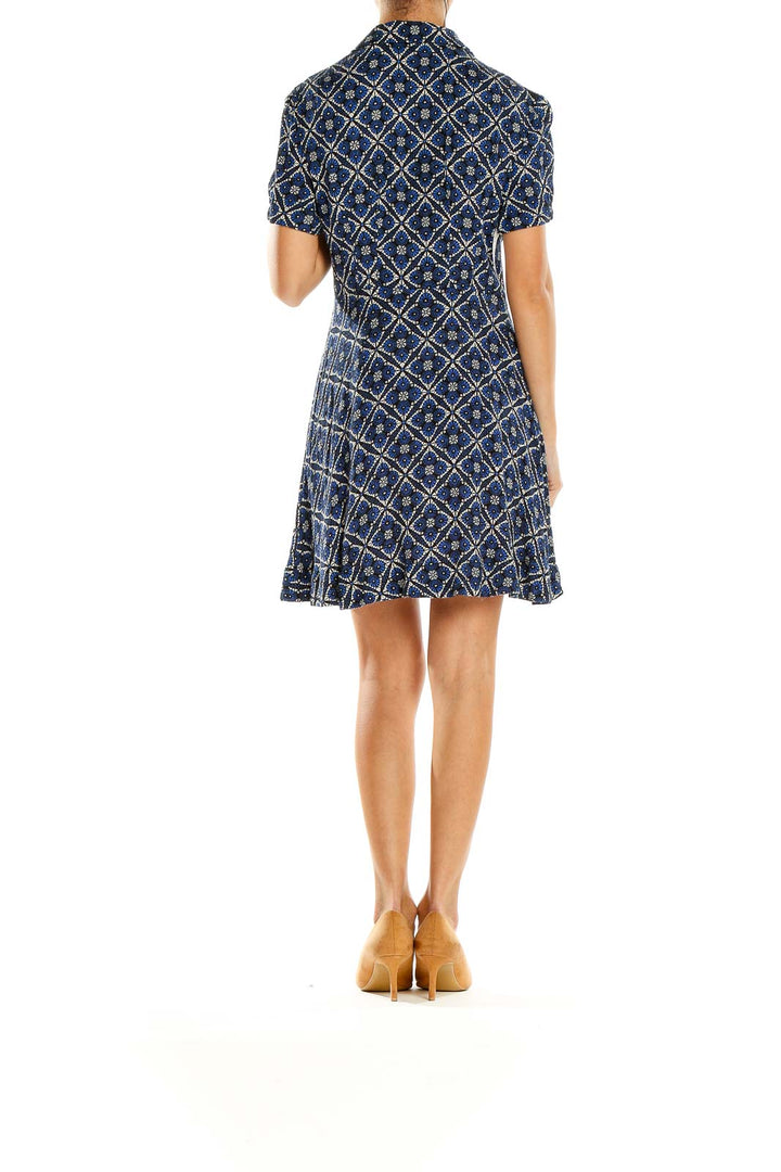 Back view of Free People blue geometric print mini dress showing flared skirt