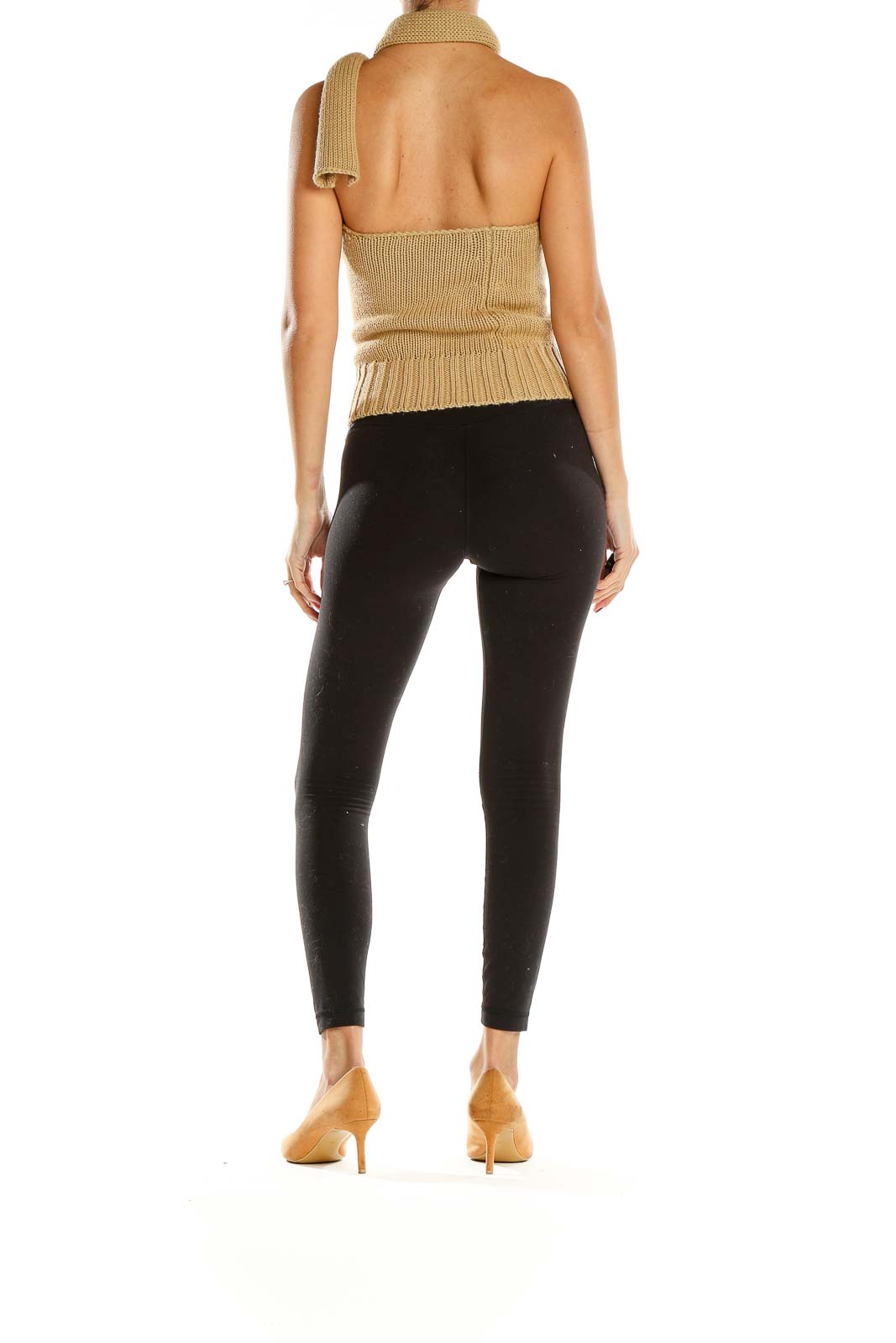 Side view of Sisley beige asymmetrical halter neck knit top with black pants