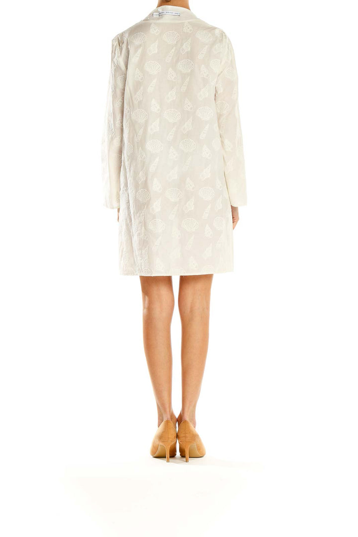 Side view of white embroidered V-neck shift dress from & Other Stories
