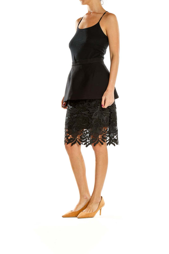 Front view of Cameo The Label black peplum skirt with lace overlay