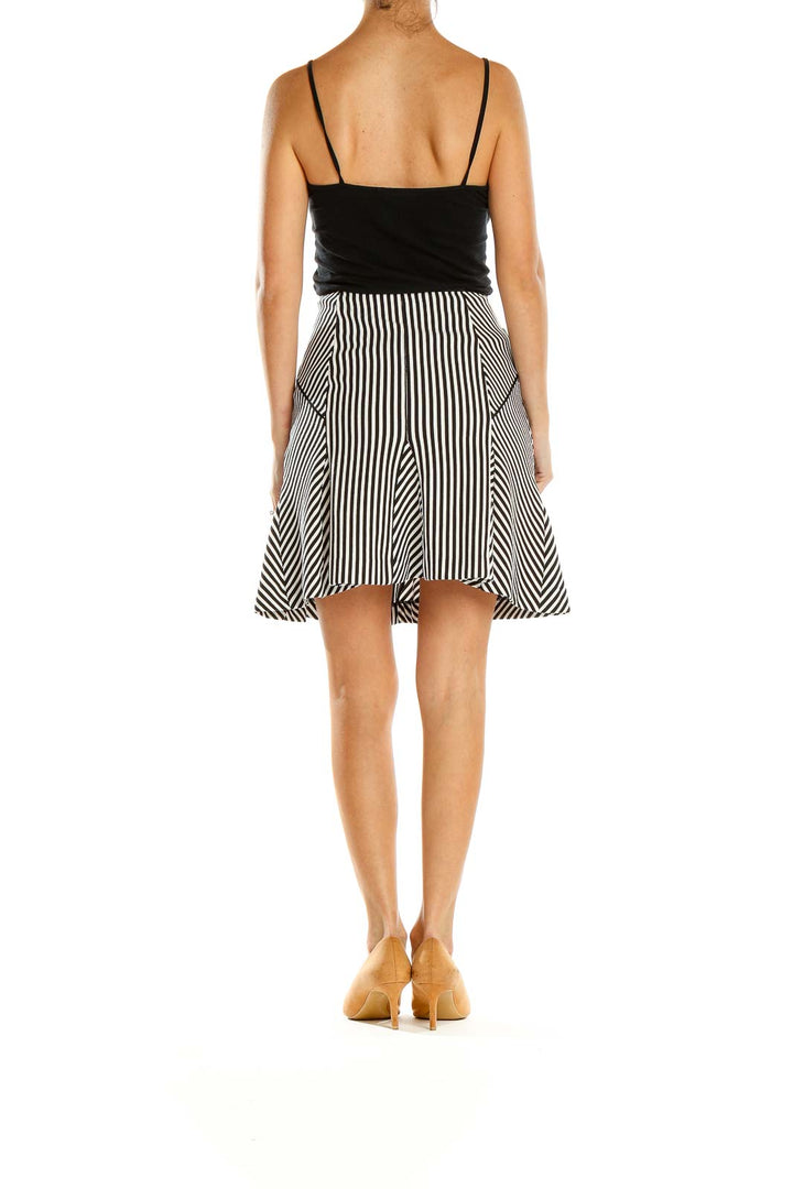 Side view of Banana Republic black and white striped A-line skirt on model