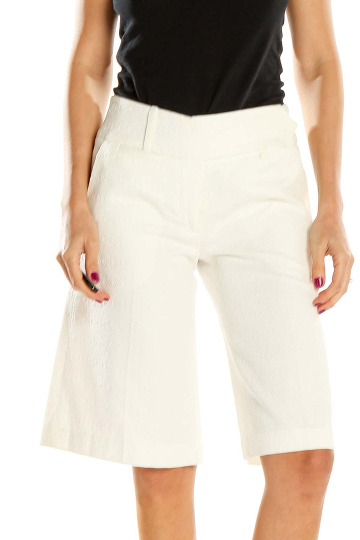 Front view of Milly white tailored Bermuda shorts on model
