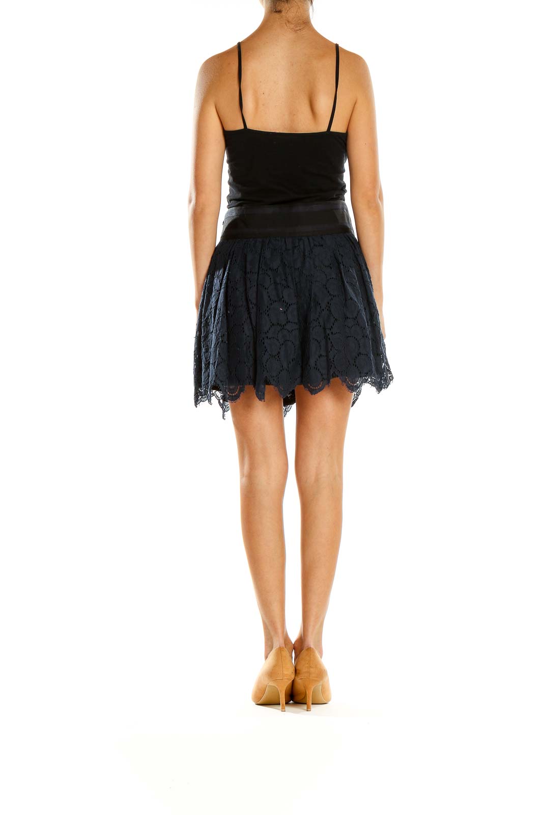 Side view of model wearing Milly navy lace mini skirt with black top