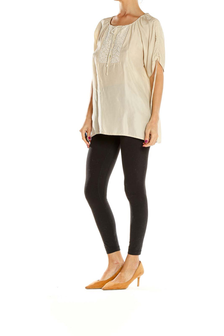 Front view of beige Banana Republic peasant blouse with embroidery