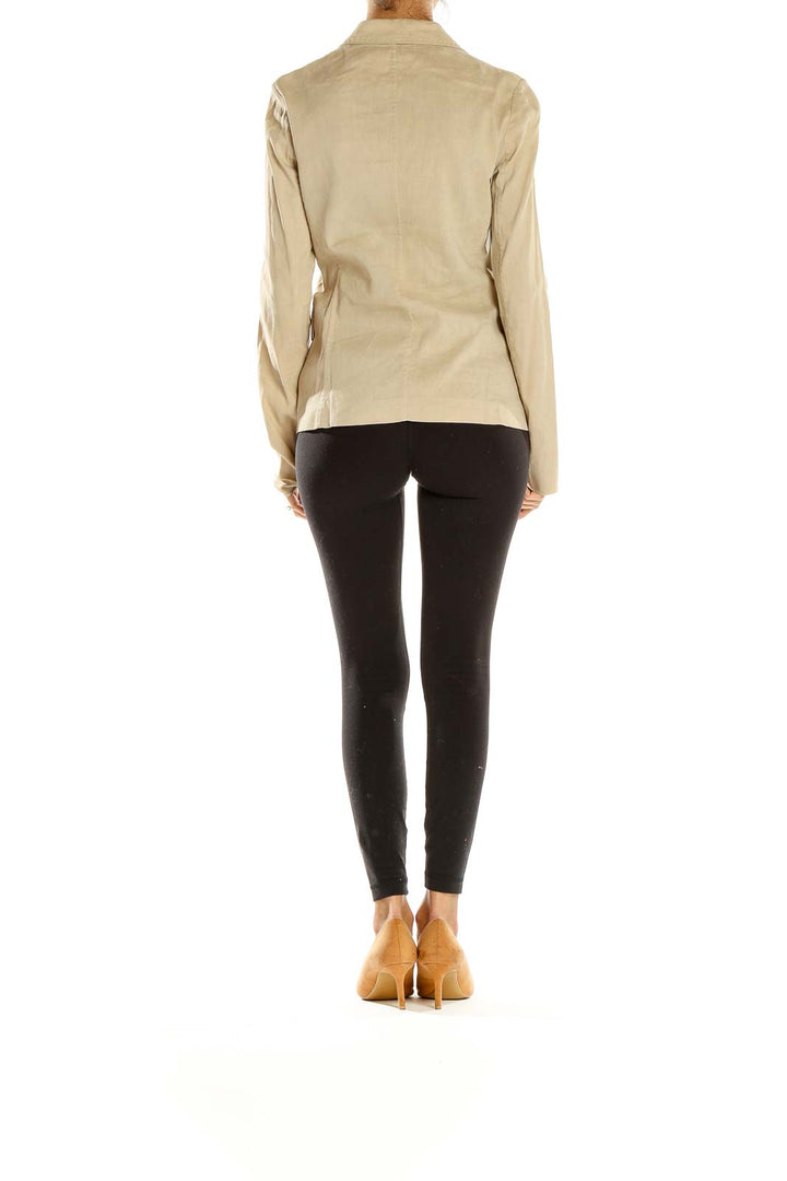 Side view of Elie Tahari beige tailored blazer on model