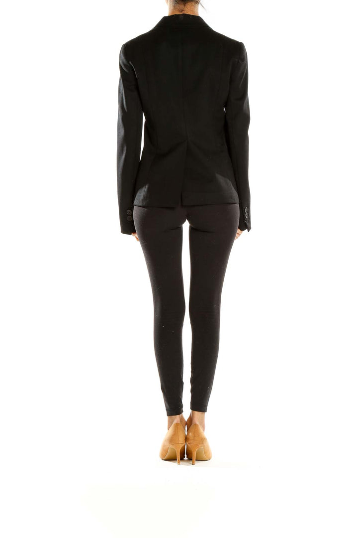 Side view of black Theory blazer showing tailored silhouette