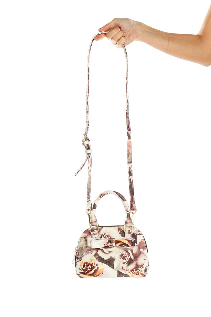 Front view of Betsy Johnson floral print mini crossbody bag with gold-tone hardware