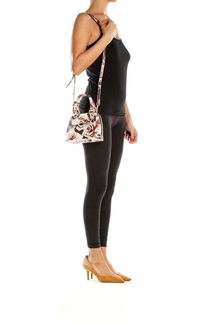 Front view of Betsy Johnson floral print mini crossbody bag with gold-tone hardware