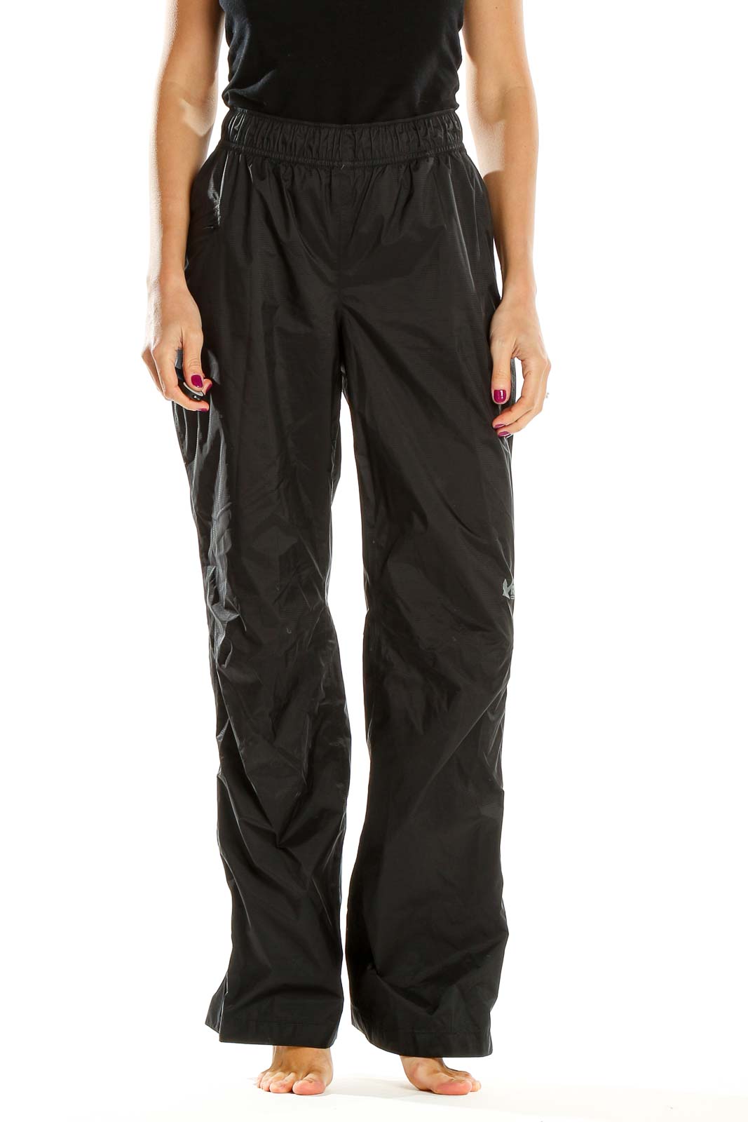 Front view of black REI hiking pants with elastic waistband