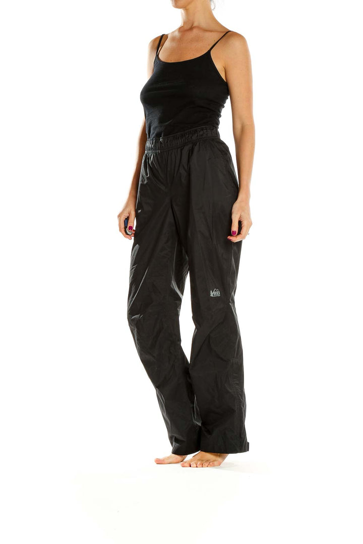 Front view of black REI hiking pants with elastic waistband