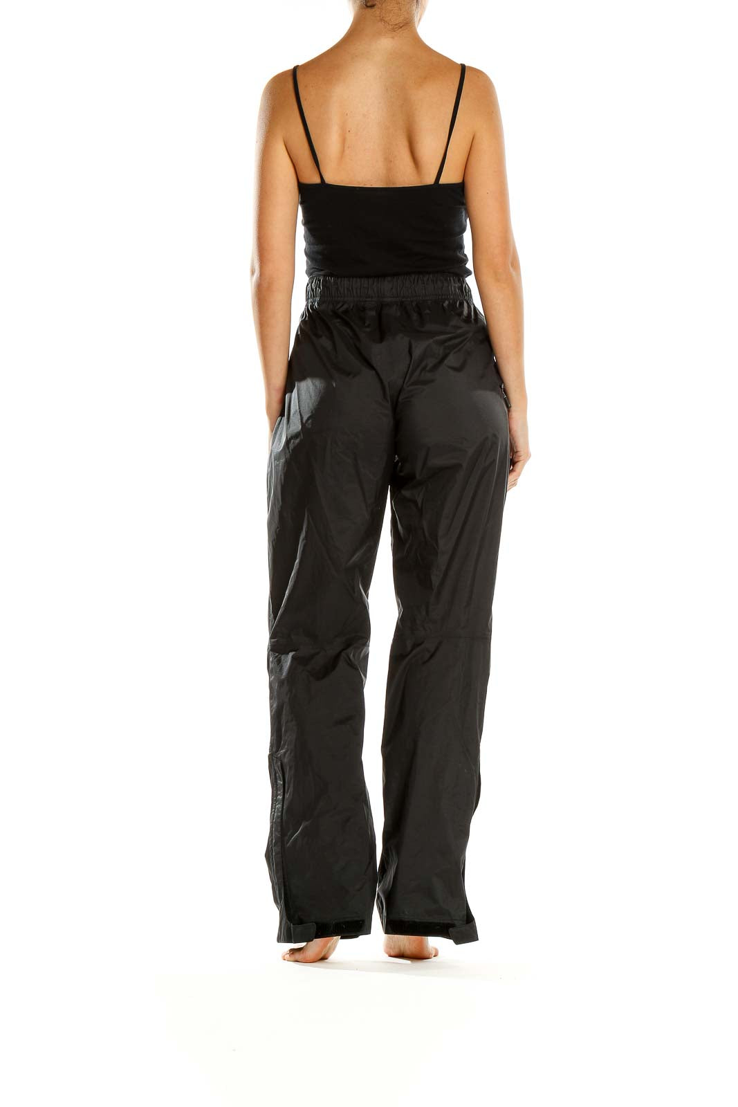 Side view of woman wearing black REI hiking pants