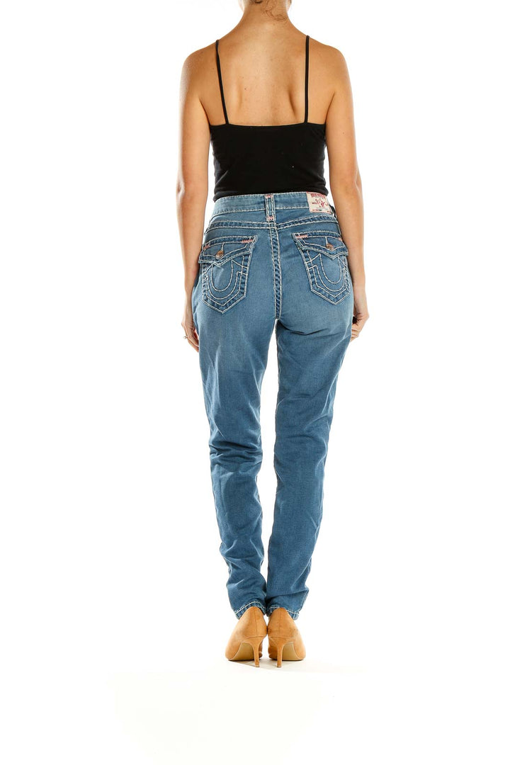 Side view of True Religion light blue straight leg jeans on model