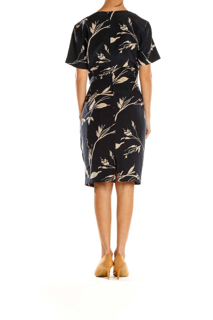 Side view of Adrianna Papell Black Floral Print Short Sleeve Dress showing fitted silhouette