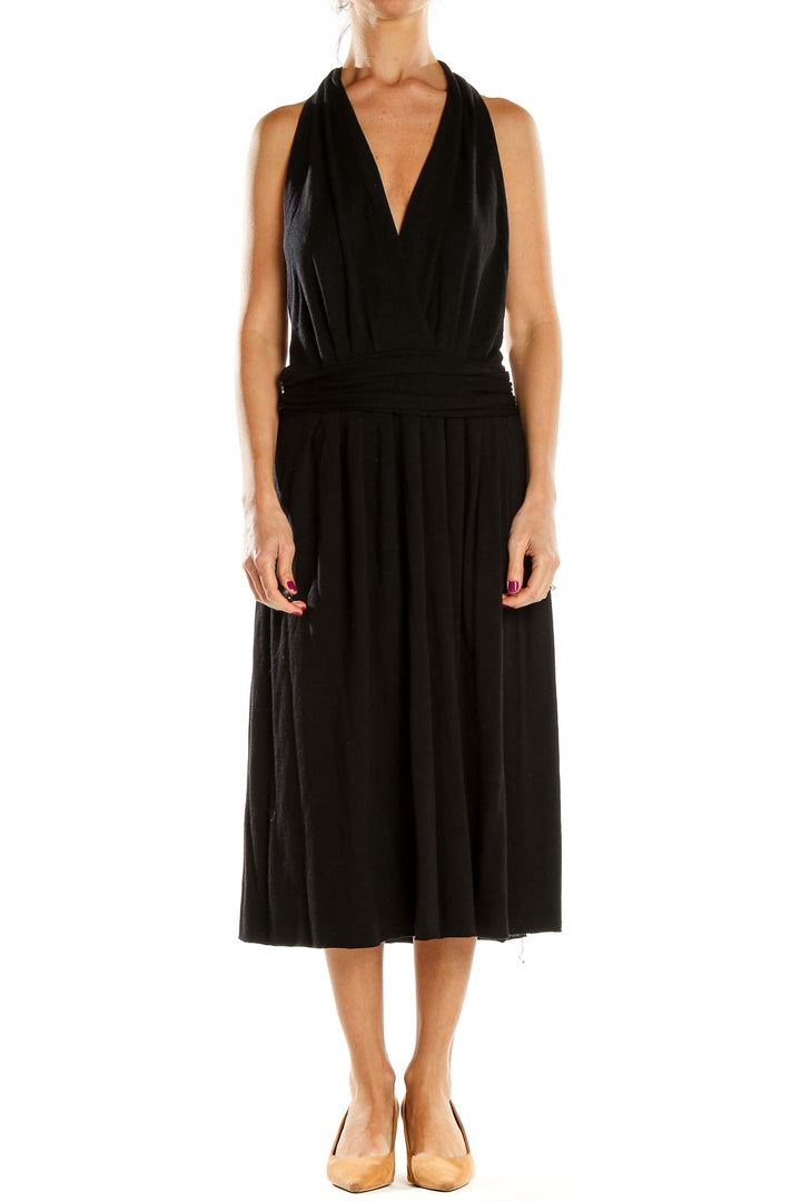 Front view of black Theory halter neck midi dress with pleated skirt