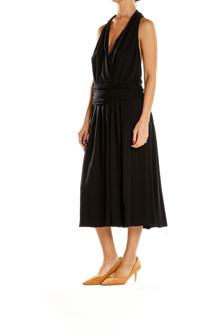 Front view of black Theory halter neck midi dress with pleated skirt