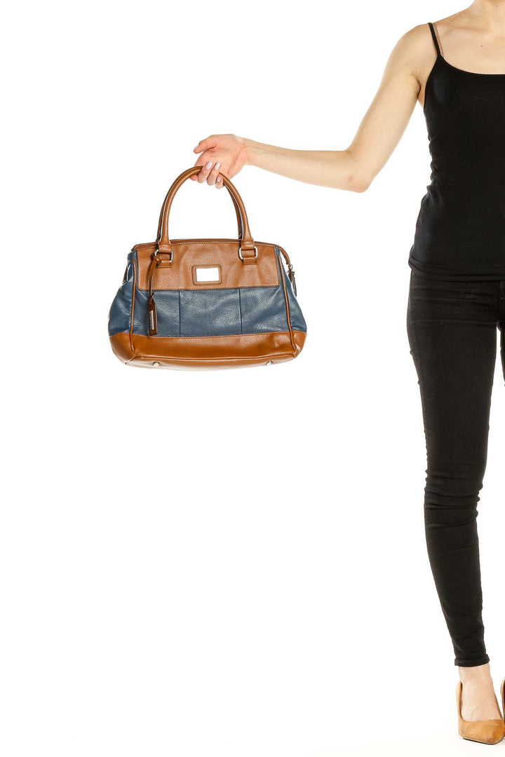 Front view of Tignanello brown and blue leather satchel held by hand