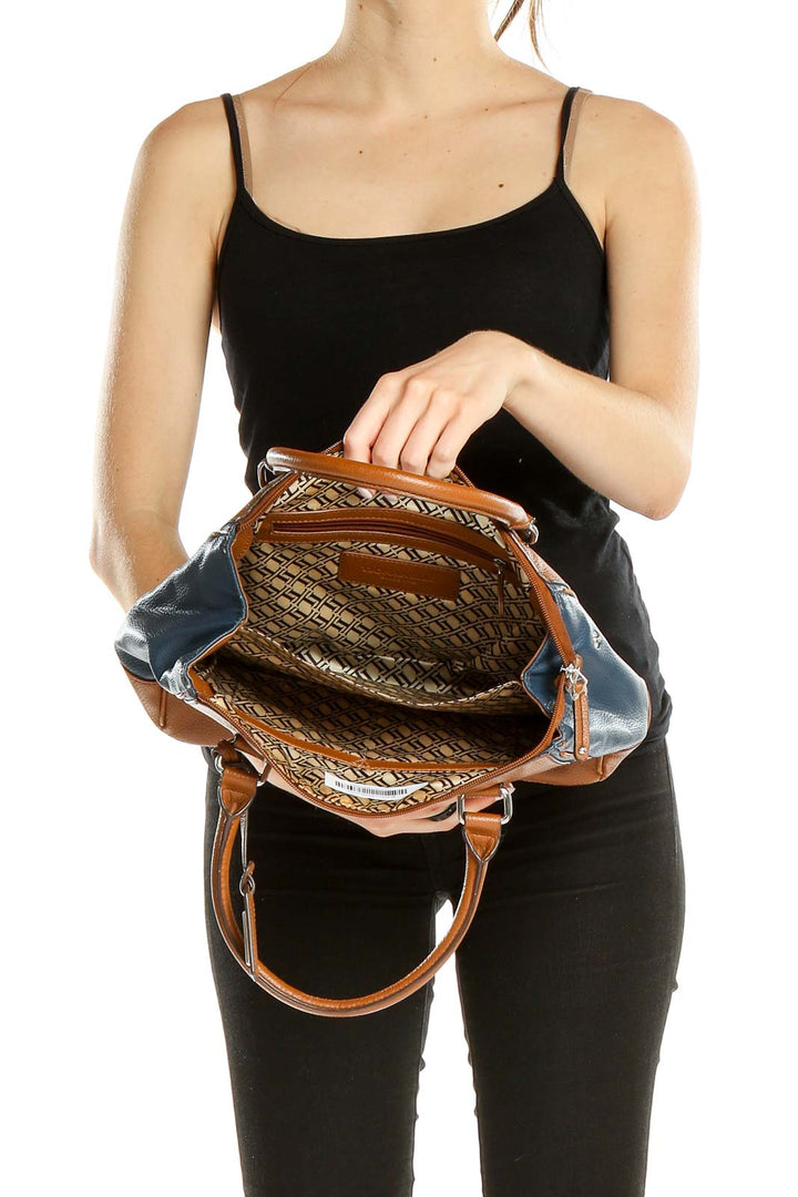 Side view of Tignanello brown and blue leather satchel worn by model