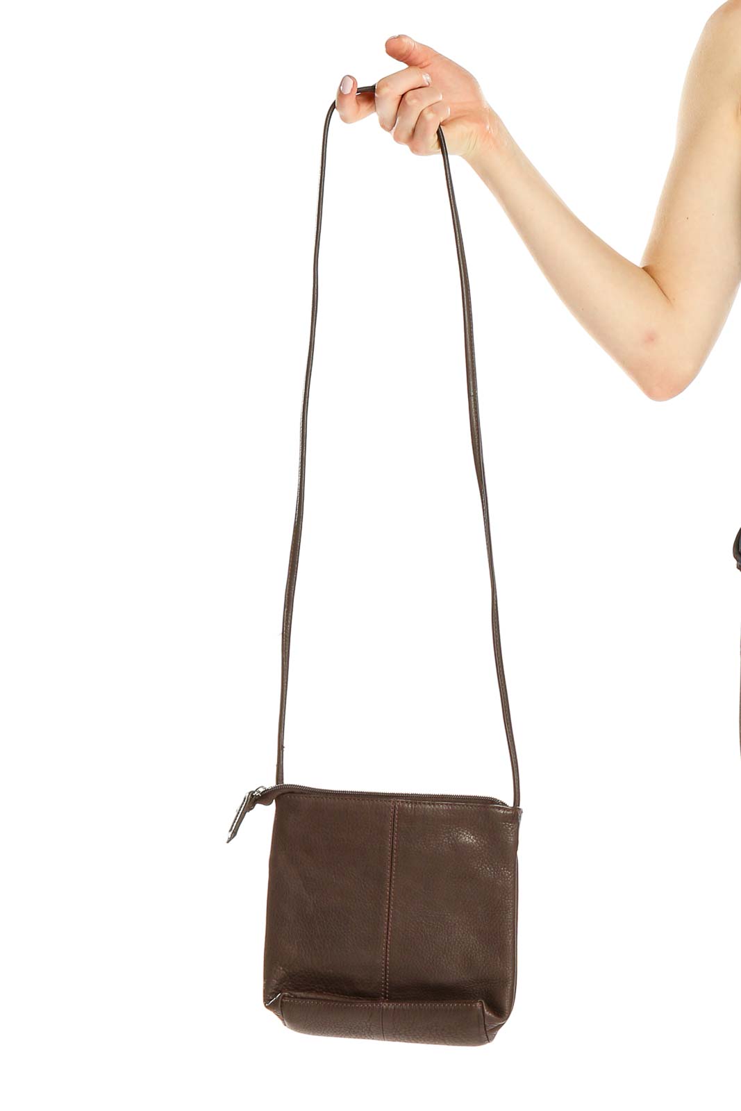 Front view of Stone Mountain brown leather crossbody bag held by hand