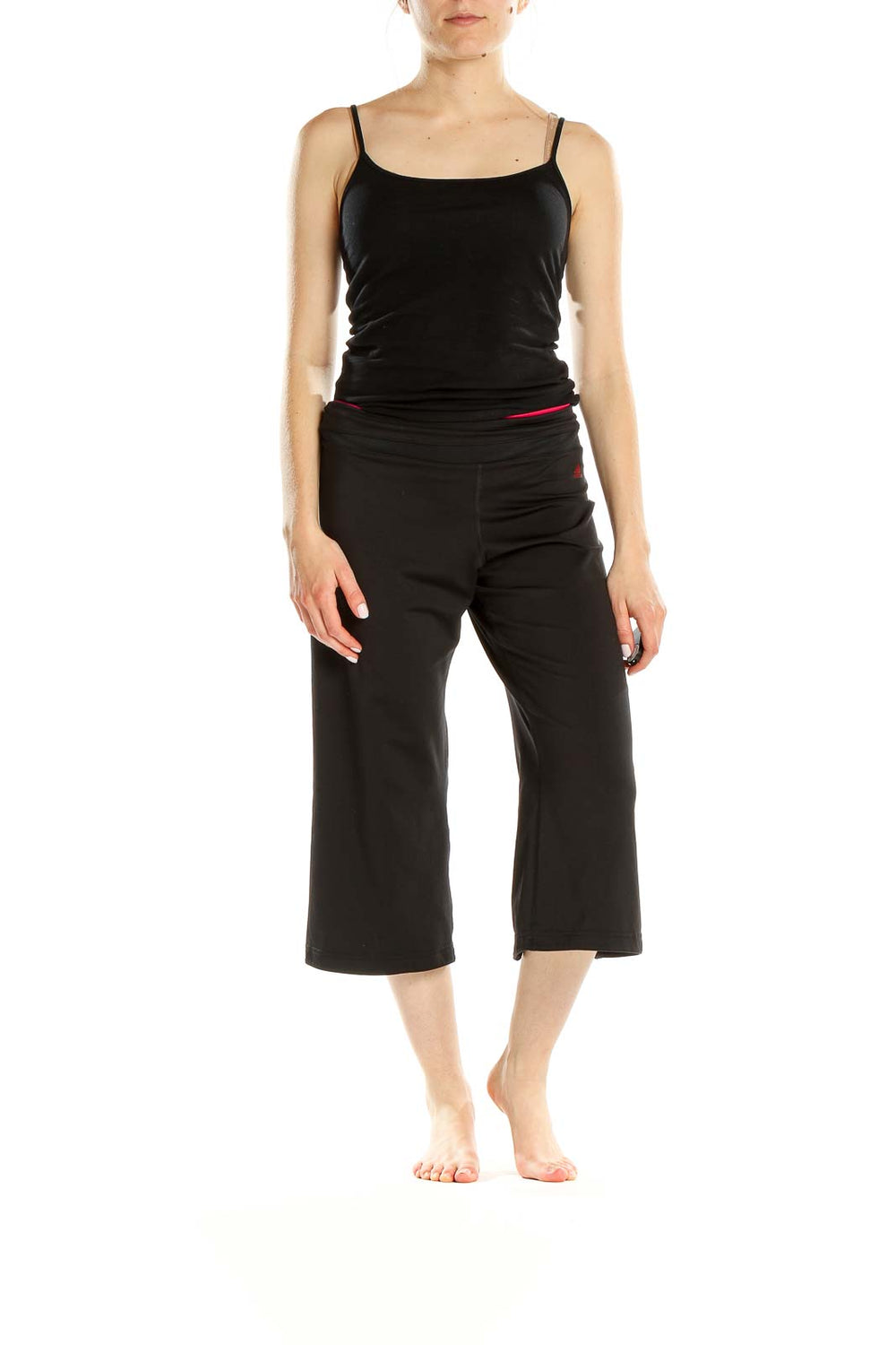 Front view of black Adidas capri yoga pants with red waistband accent