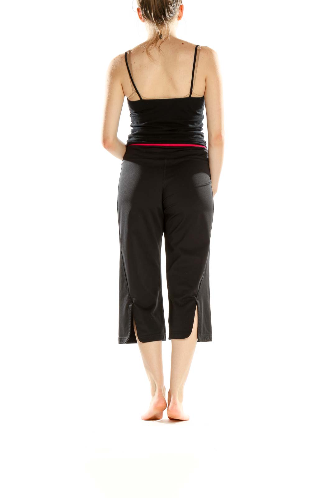 Side view of woman wearing black Adidas capri yoga pants
